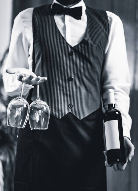 Sommelier holding wine bottle and wine glasses