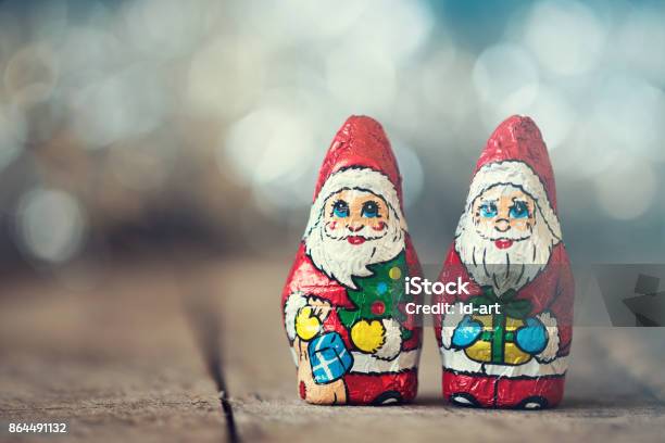 Chocolate Santa Claus With A Bag On A Old Wooden Background Stock Photo - Download Image Now