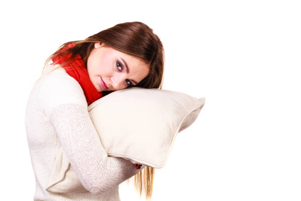 istock Woman sleepy tired with pillow almost falling asleep 864492840