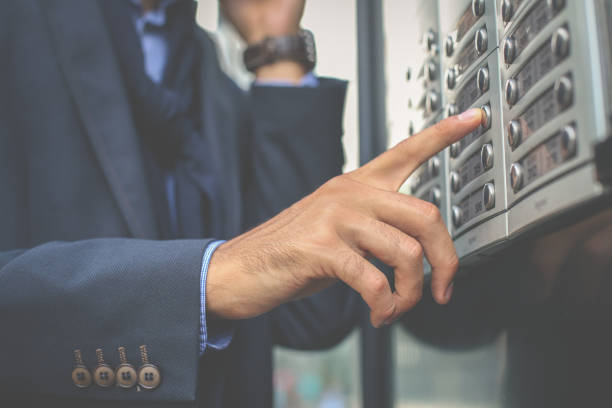 istock Businessman pushing bottom on building. Focus is on hand. 864494004