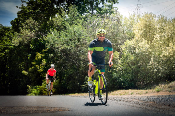 istock Determined young man cycling on country road 864494398