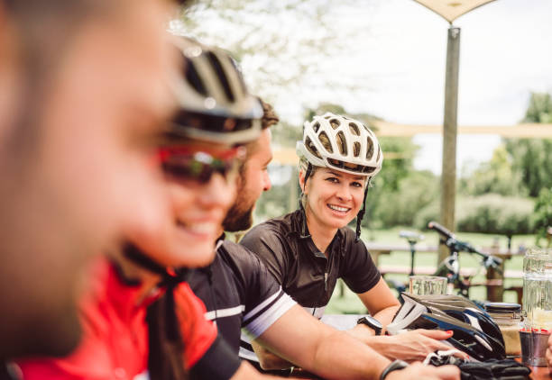 istock Smiling female cyclist with friends in yard 864494530