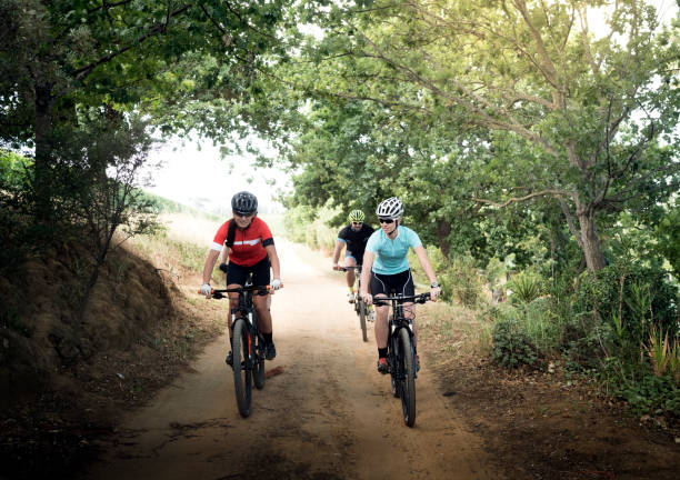 istock Young cyclists riding bicycles on dirt road 864496308