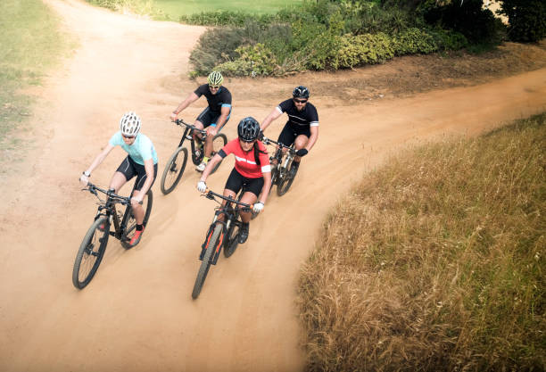 istock Friends riding bicycle on dirt road 864496310