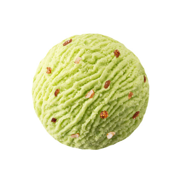 Pistachio ice cream scoop with raisins nuts pieces Green pistacchio kiwi sorbet ice-cream ball with dried fruits nuts maclura pomifera stock pictures, royalty-free photos & images