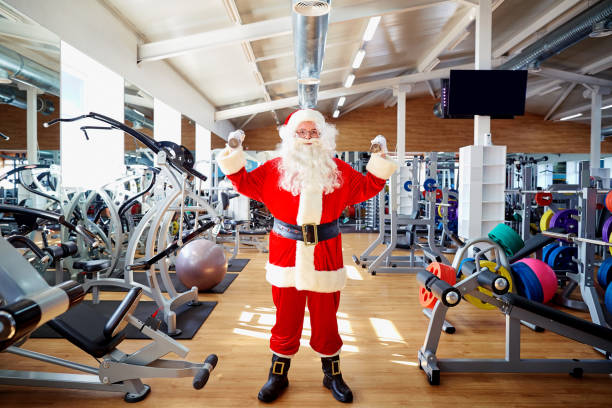 istock Santa Claus in the gym doing the exercises 864496664