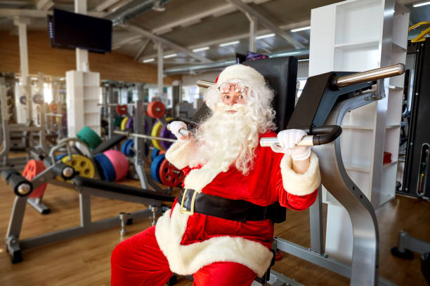 istock Santa Claus in the gym doing the exercises 864496776