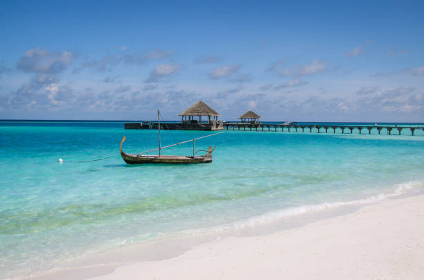 Traditional boat floating in lagoon in the Maldives