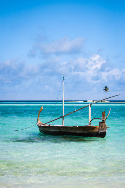 Traditional boat floating in lagoon in the Maldives
