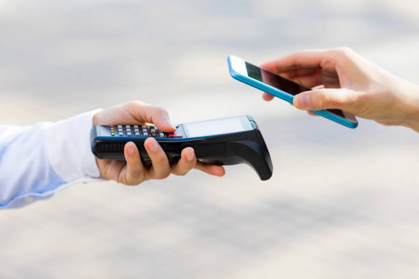 istock handy terminal and smart phone. Cashless settlement. 864500316