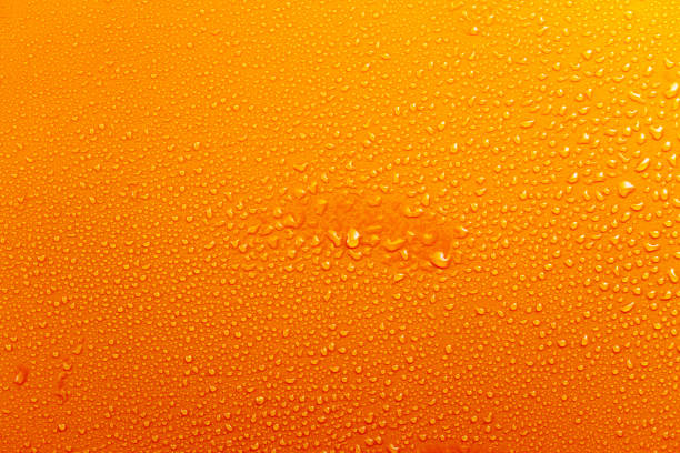 istock Water Drops On Orange Background Texture colorful waterdrop central spot 864500666
