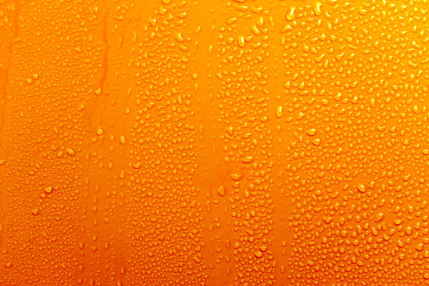 istock Water Drops On Orange Background Texture colorful waterdrop with streaks 864504568