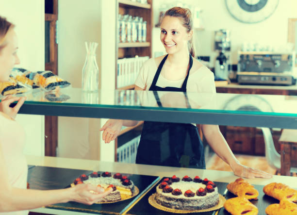 istock Bakery female worker with delicious pies and rolls on counter 864504890