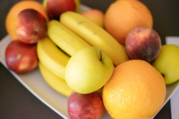 Horizontal shot with mix of whole fruit, vegetarian eating and well-being concept, five-a-day, and health benefits through vitamins intake.