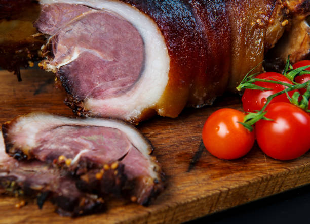 istock Roast pork knuckle and ingredients close-up on a slate board. 864506132
