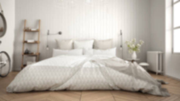 istock Blur background interior design, white and gray modern bedroom with cozy double bed, brick wall, wooden floor and big window, scandinavian minimalist architecture, close-up 864508368