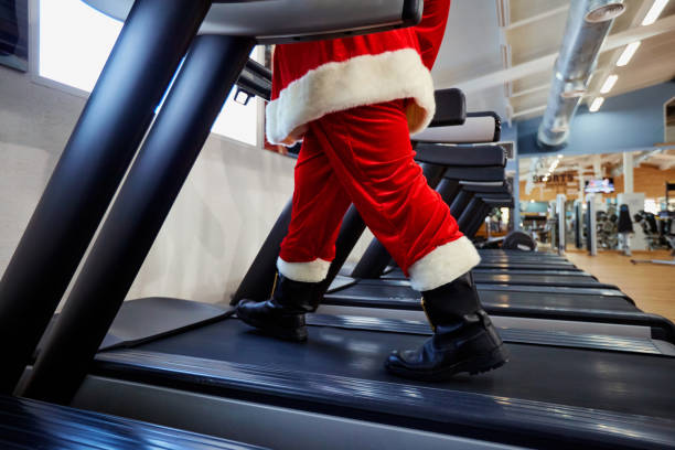 istock Santa Claus in the gym doing exercises 864508638