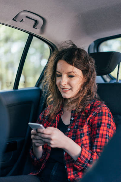 istock Woman with mobile phone in a car 864508736