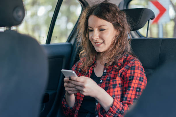 istock Woman with mobile phone in a car 864508912