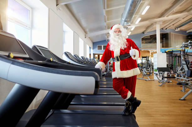 istock Santa Claus in the gym doing exercises 864509116