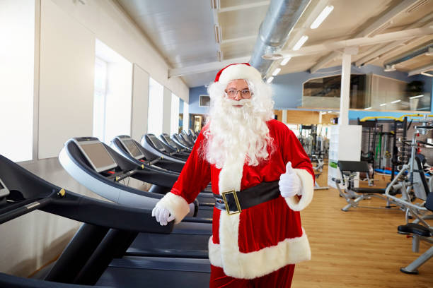 istock Santa Claus in the gym doing exercises 864509252