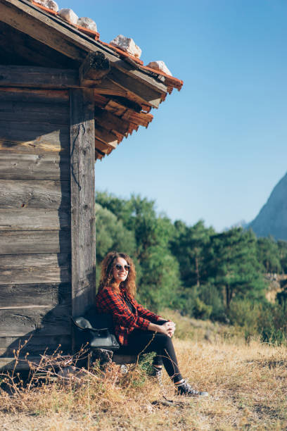 istock Woman sitting and looking at mountain 864510412