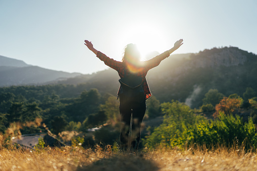 Hiker woman walking outdoor at sunset