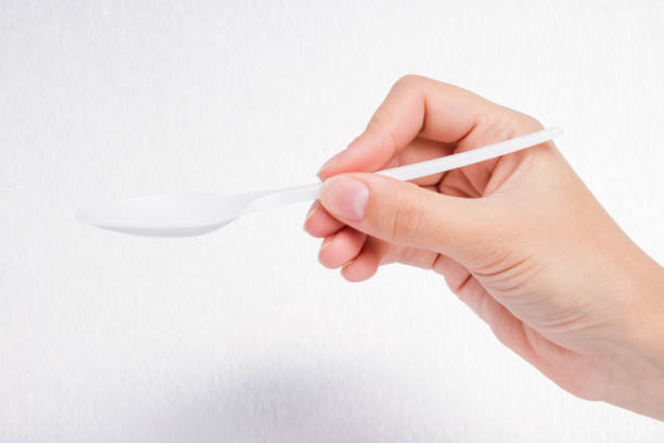 istock doctor holds empty spoon on gray background3 864519478