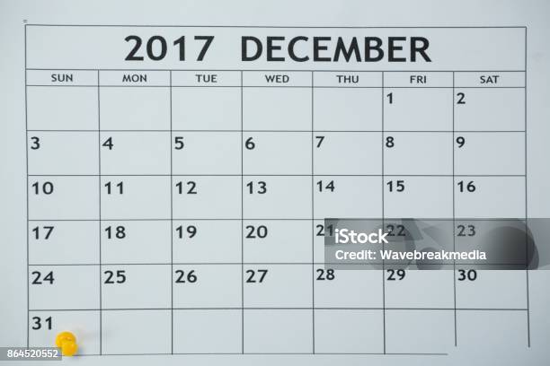 Yellow Pin Push On Day 31st Of Month End On White Calendar Stock Photo - Download Image Now