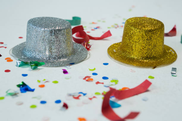 istock Golden and silver hat with confetti on white background 864521152
