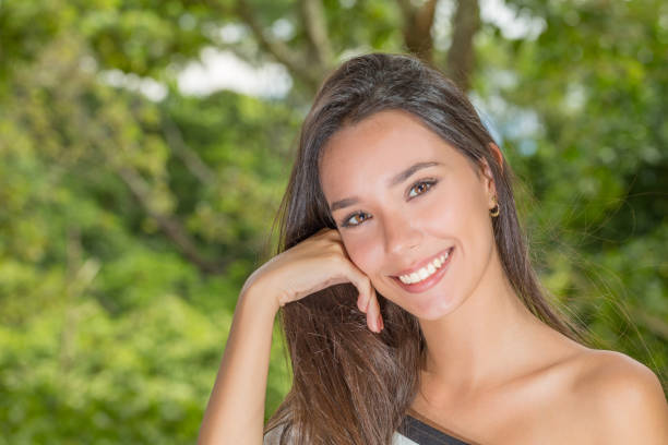 istock Beautiful Young Lady Portrait Smiling with Hand on Face 864523482
