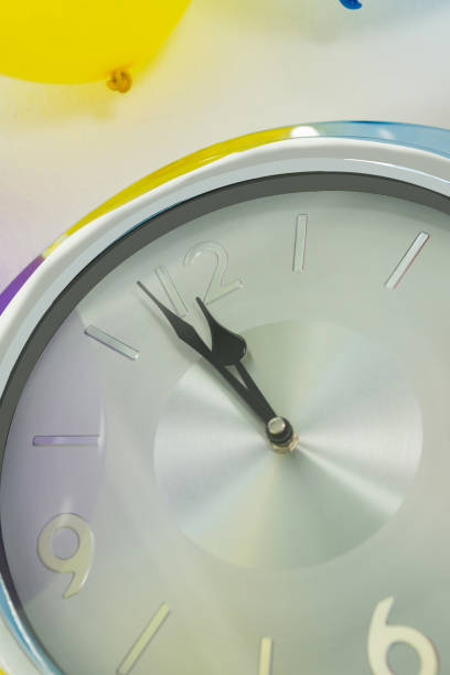 istock Balloon and clock hands reaching 12 o clock midnight 864523494