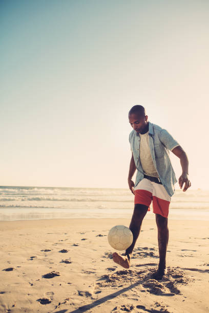 istock African man playing with football 864525384