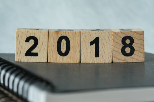 istock selective focus on wooden cube block with number 2018 on black notebook as new year 2018 aim or goals concept 864525632