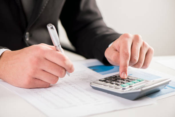 istock Accounting concept.Analyzing finance report with calculator 864526224