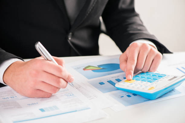 istock Accounting concept.Analyzing finance report with calculator 864526704