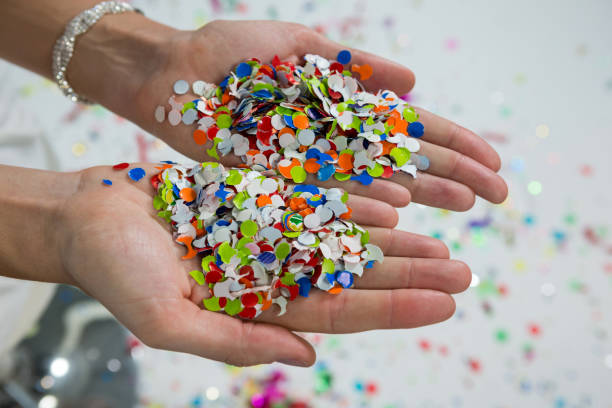 istock Woman holding confetti in hands 864526730