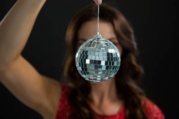 istock Woman holding mirror ball 864526760