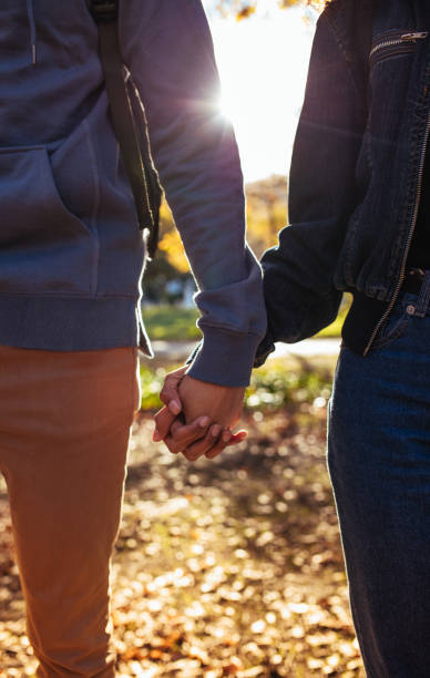 istock Man and woman holding hands 864528062