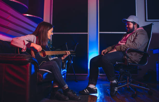 istock Musicians composing a song in recording studio 864529472