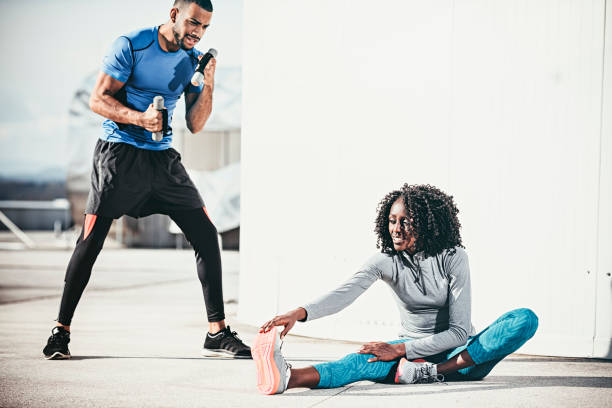istock Two young people warming up and stretching outdoors 864531932