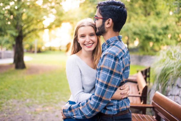 istock Young couple hugging in the park 864535912