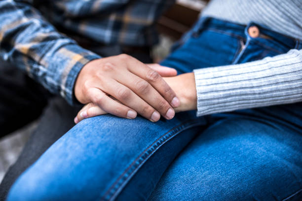 istock Close up of a couple holding hands 864535928