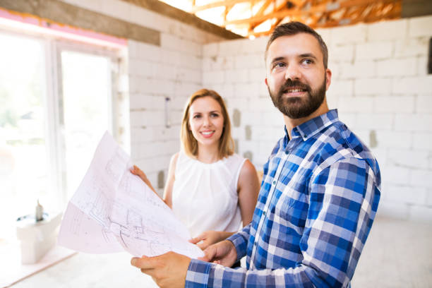 istock Young couple at the construction site. 864536200