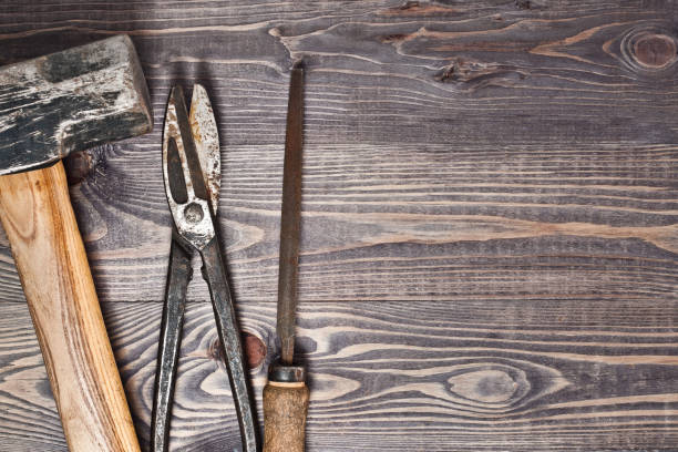 istock A large construction hammer, old rusty metal shears, an old rusty file on a rustic wooden background 864536802
