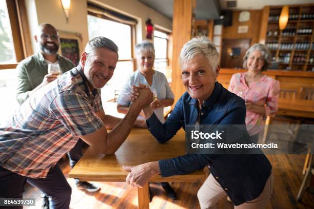 Happy Friend Arm Wrestling Each Other Stock Photo - Download Image Now - 40-44 Years, 40-49 Years, 45-49 Years