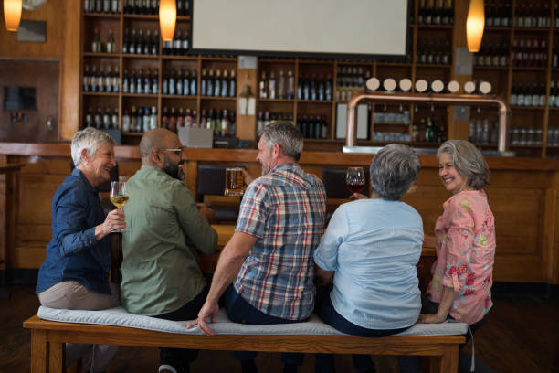 istock Happy friends having drinks in bar 864540112