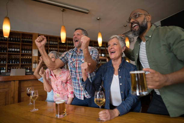 istock Excited friends watching soccer match 864540354
