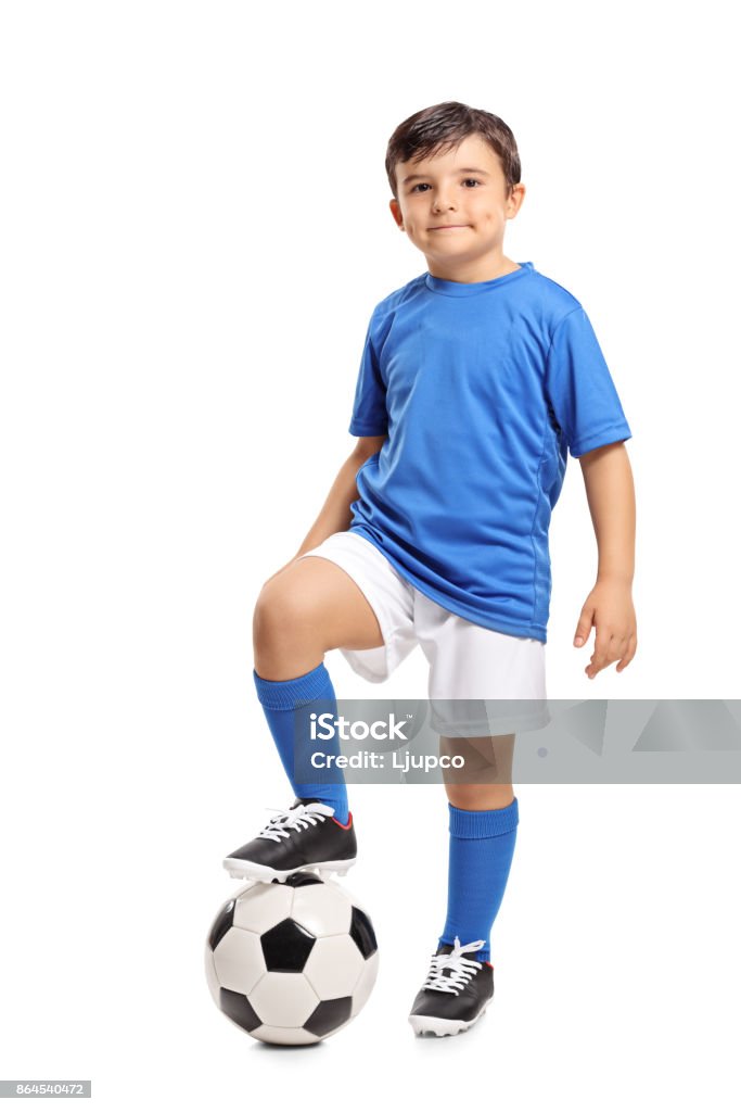 Little footballer Full length portrait of a little footballer isolated on white background Child Stock Photo