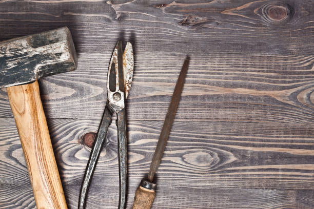 istock A large construction hammer, old rusty metal shears, an old rusty file on a rustic wooden background 864542306